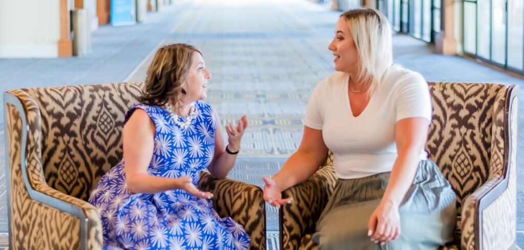 Fran and Jessica haveing a conversation in a hotel event spacesetting